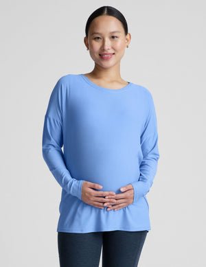 blue long sleeve maternity top with a crew neckline.