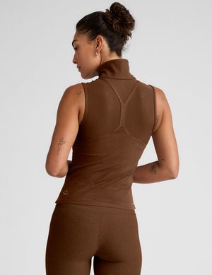 brown zip-up vest with a mesh upper back detail and pockets.