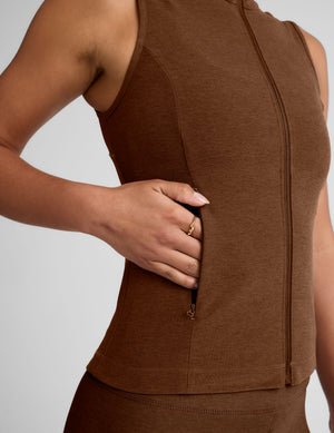 brown zip-up vest with a mesh upper back detail and pockets.
