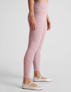 pink high-waisted midi length leggings.
