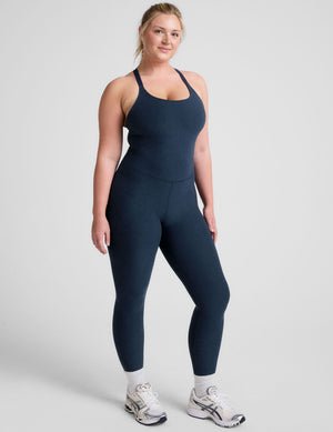 blue midi length jumpsuit with cross straps on back.