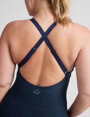 blue midi length jumpsuit with cross straps on back.