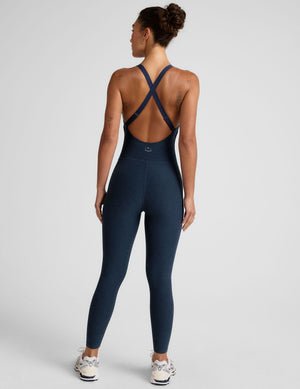 blue midi length jumpsuit with cross straps on back.