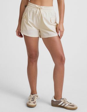 white mid-rise shorts with two side patch cargo pockets and a drawcord at waistband.